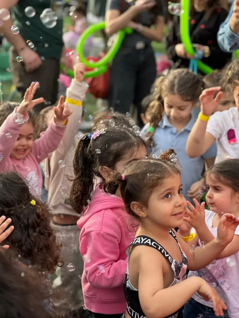 Little girl laughing among soap bubbles at Arena Dbayeh